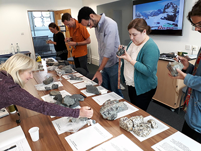 Participants 'hands on' session to learn about Ilímaussaq rocks.  Photo Copyright Adrian Finch.